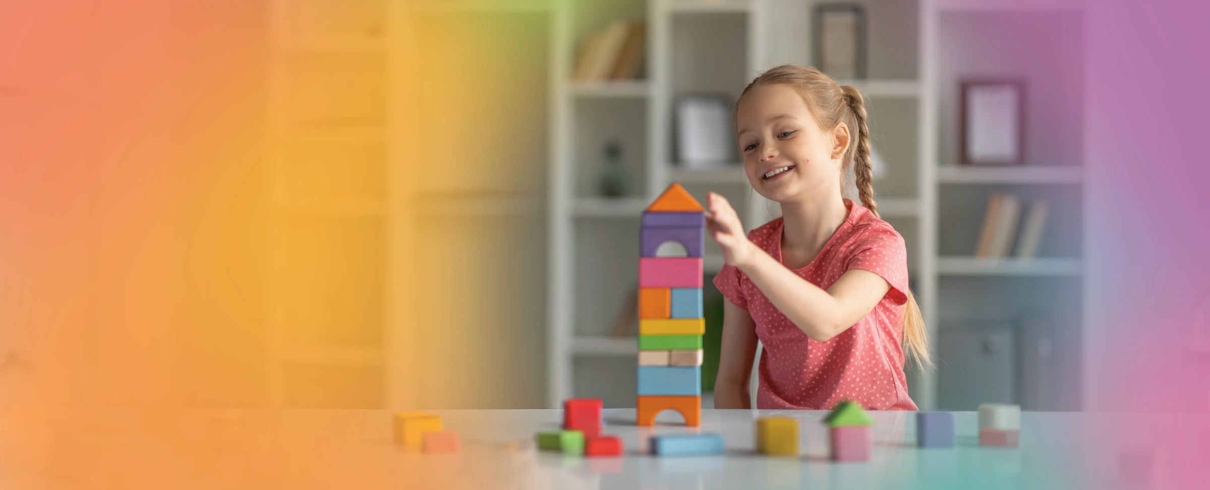 Smiling child building colorful blocks